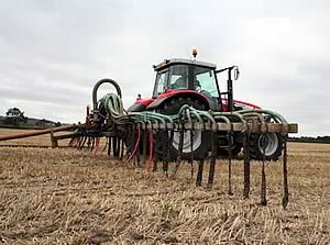 12m dribble bar in action placing cattle slurry on to wheat stubble
